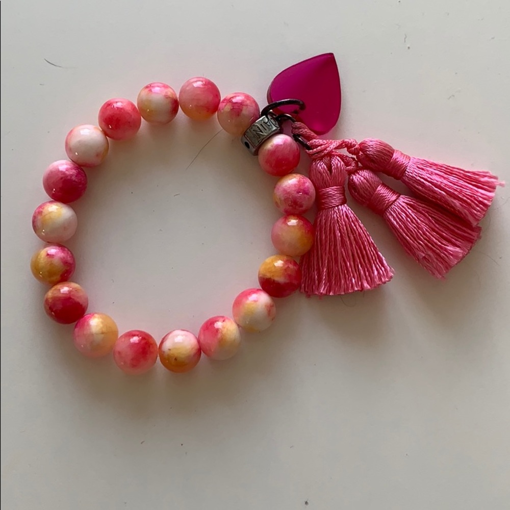 Pink bead and tassel bracelet with acrylic heart
